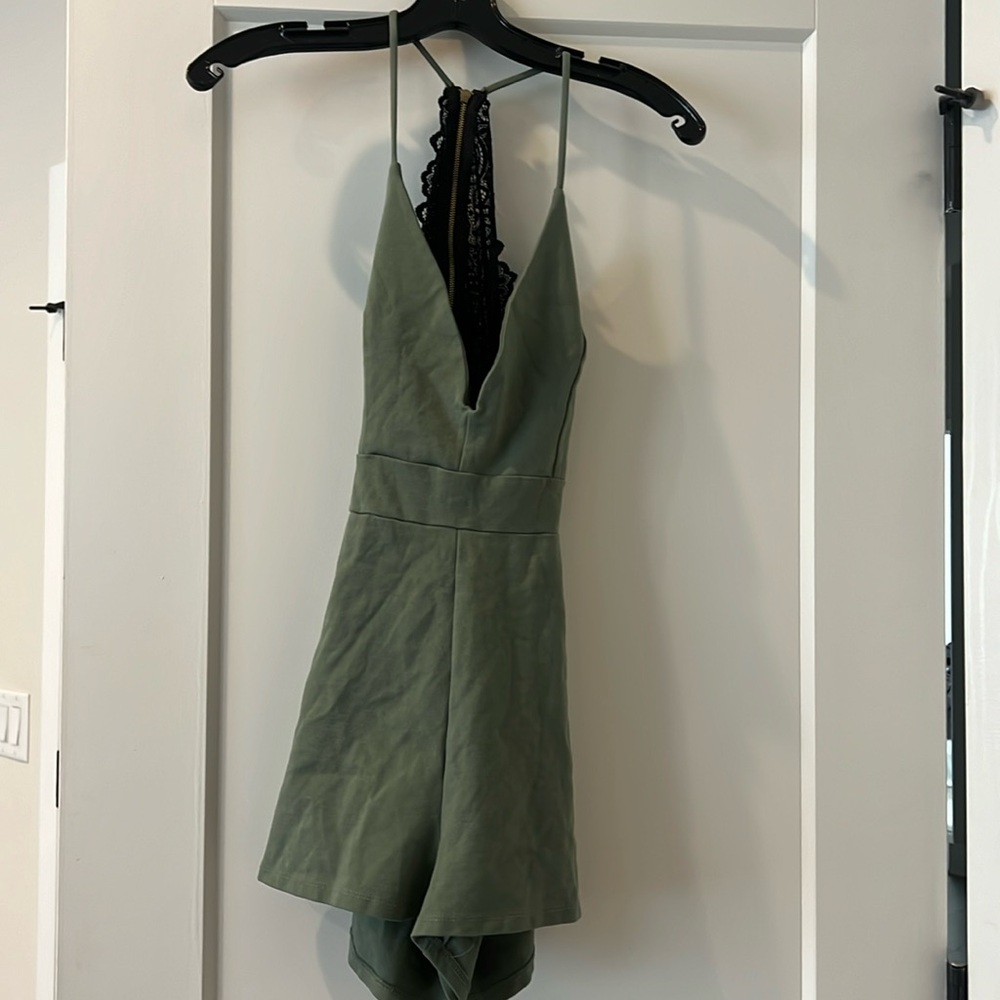 Green open back romper with black lace